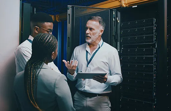 IT technicians removing servers and networking equipment during a secure data center decommissioning project for certified IT Asset Disposition and electronics recycling.